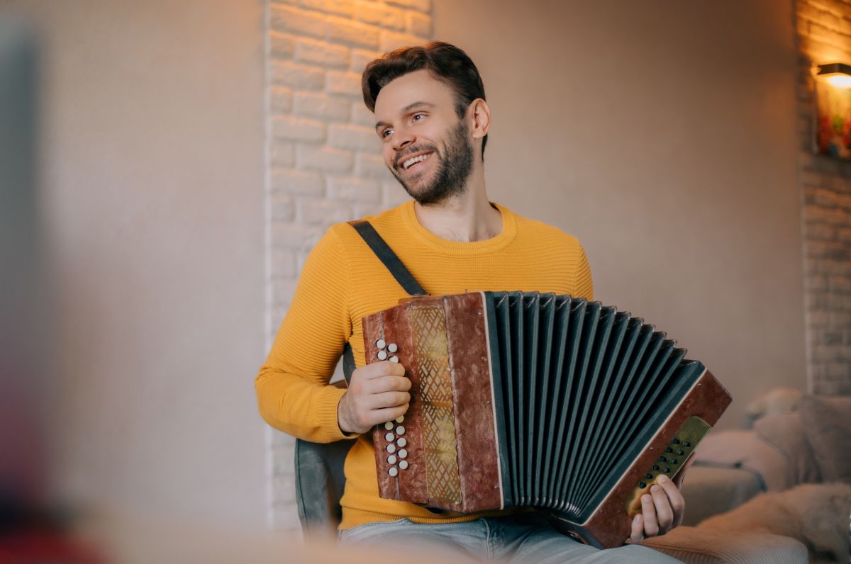A man playing the accordion at home